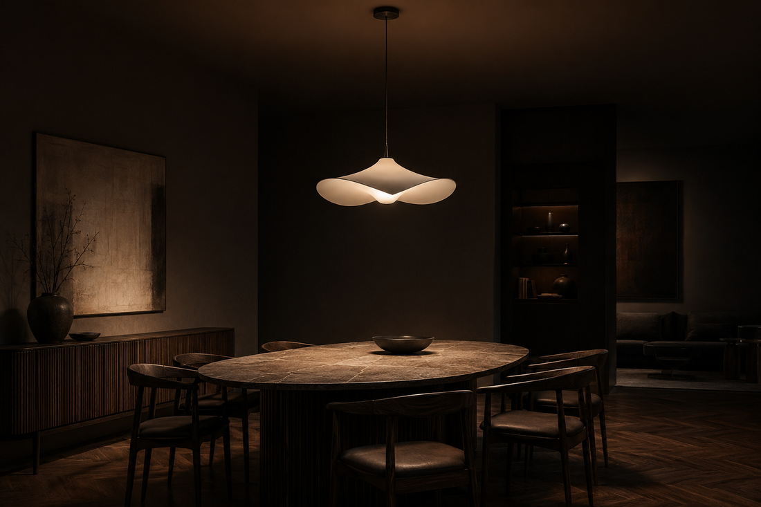 Sculptural pendant light above a dark contemporary dining table